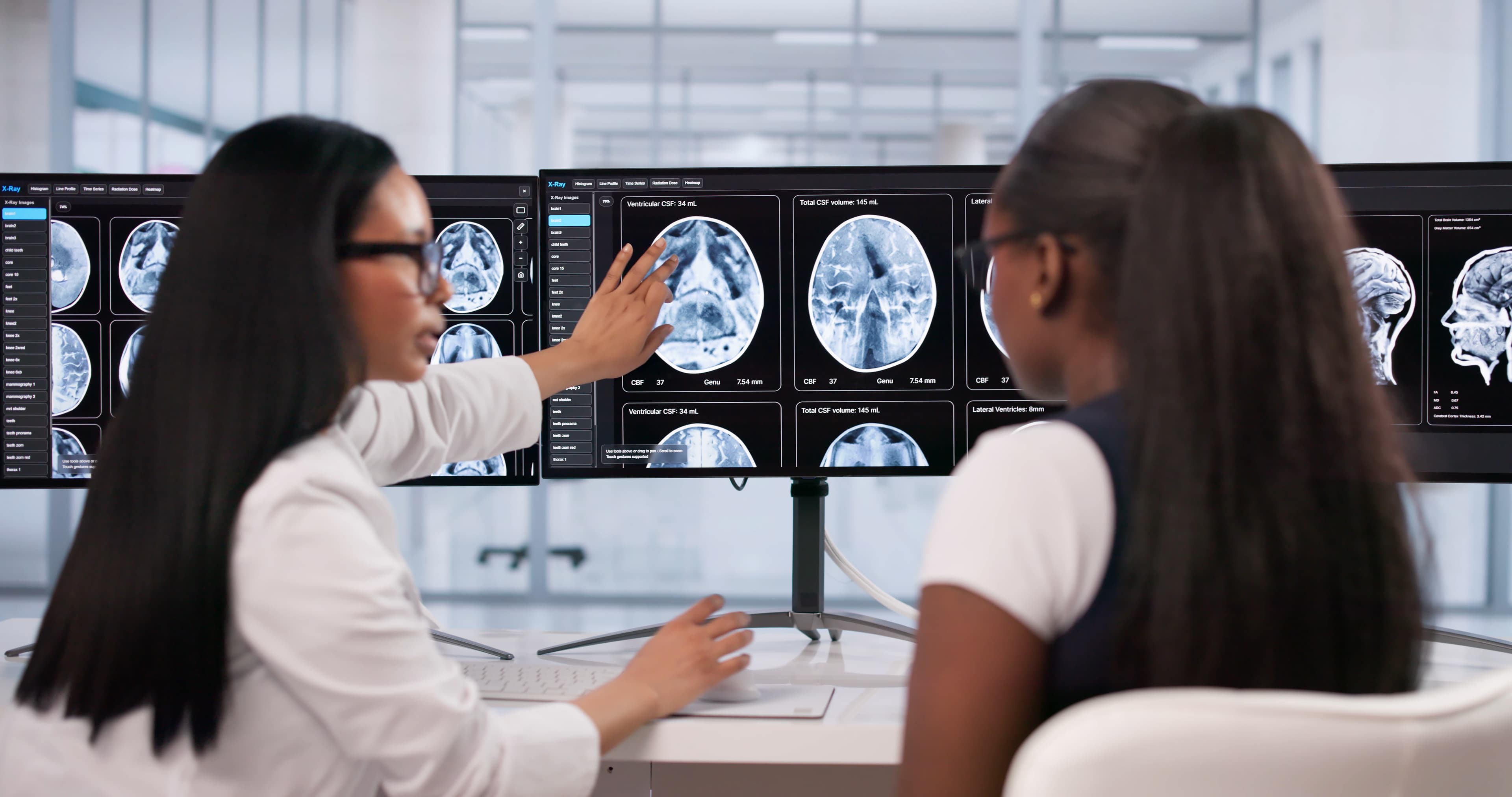 Female radiologist pointing at screen
