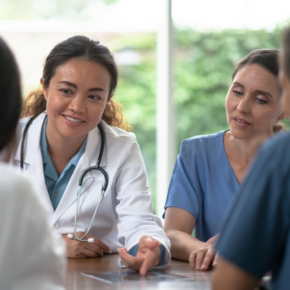 Refer a Doctor Doctor talking to nursing team
