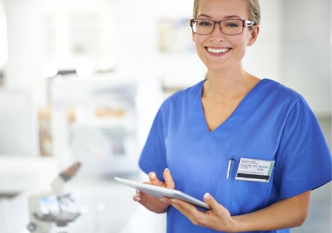 pathologist in scrubs with tablet