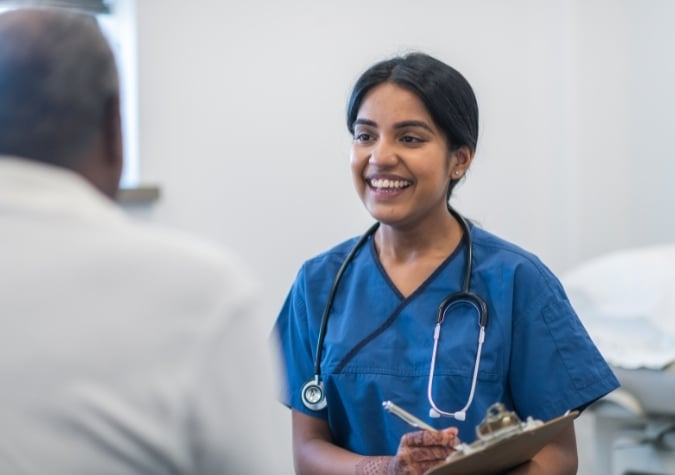 surgery intern with clipboard