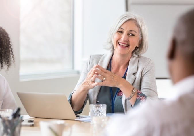 healthcare executive sitting at a desk with a laptop