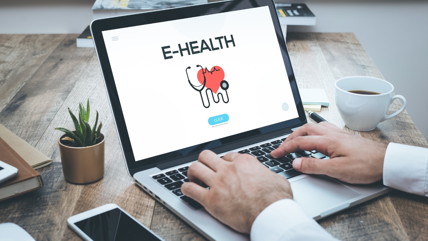 doctor with health software on laptop